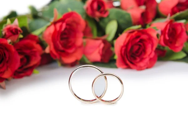 Anéis de casamento e flores isoladas no fundo branco — Fotografia de Stock