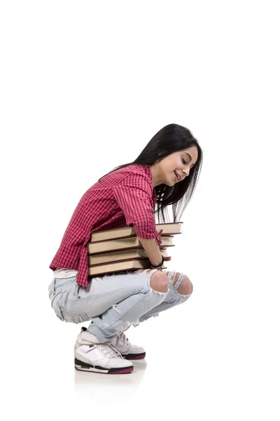 Junge Studentin mit Büchern auf Weiß — Stockfoto