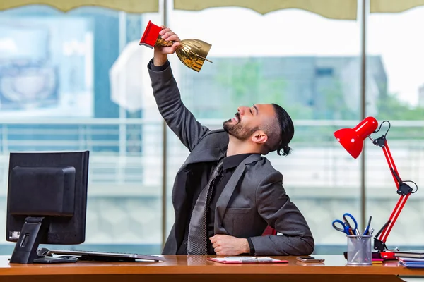 Businessman winning cup trophy in the office — Stock Photo, Image