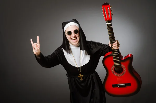 Funny nun with red guitar playing — Stock Photo, Image