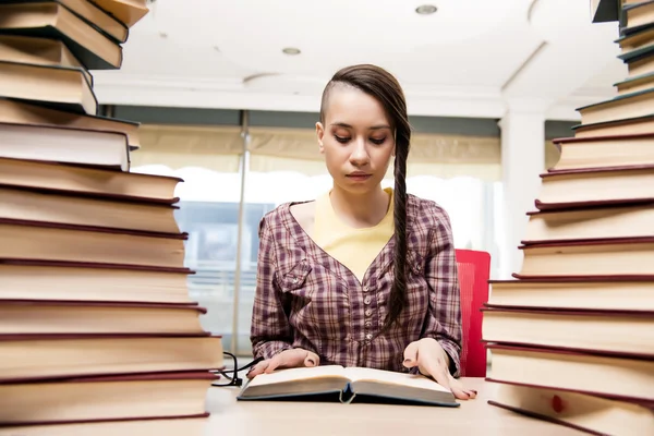 Young student with stack of books — Stock Photo, Image