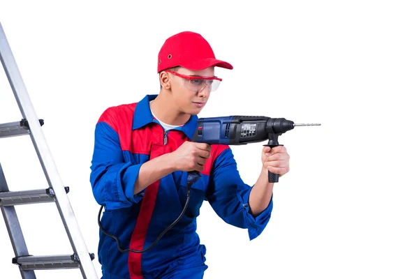 Young repairman with drill perforator isolated on white — Stock Photo, Image