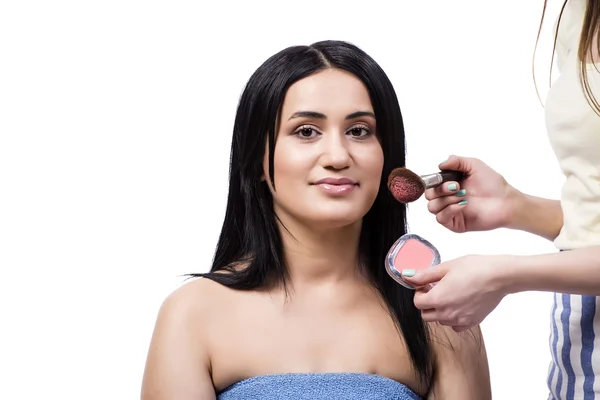 Junge Frau bekommt Make-up isoliert auf weiß — Stockfoto