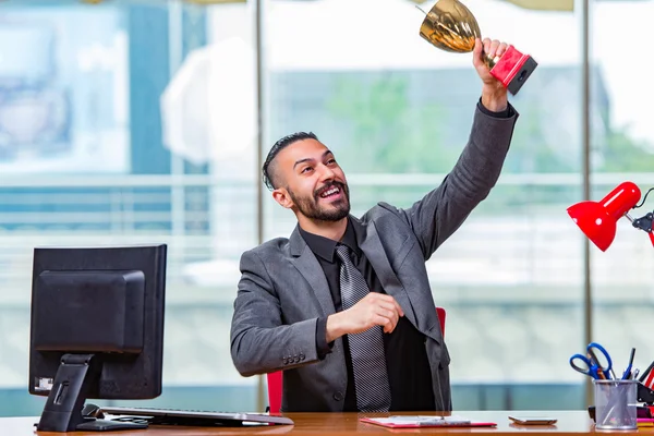 Businessman winning cup trophy in the office — Stock Photo, Image