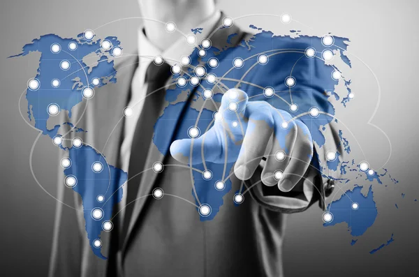 Man pressing dots on world map in global communication concept — Stock Photo, Image