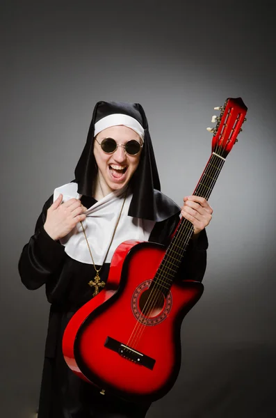 Funny nun with red guitar playing — Stock Photo, Image