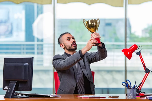 Empresário ganhando troféu copo no escritório — Fotografia de Stock