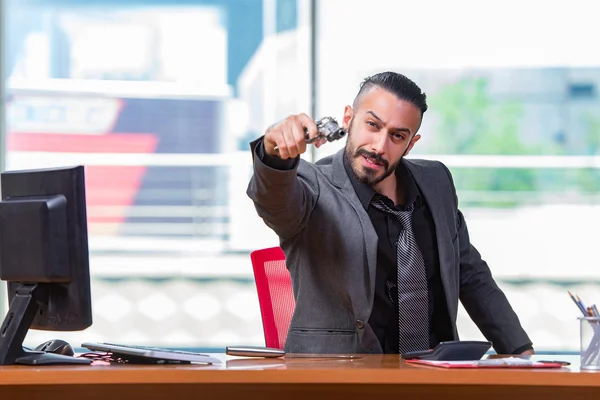 Angry aggressive businessman with gun in the office — Stock Photo, Image