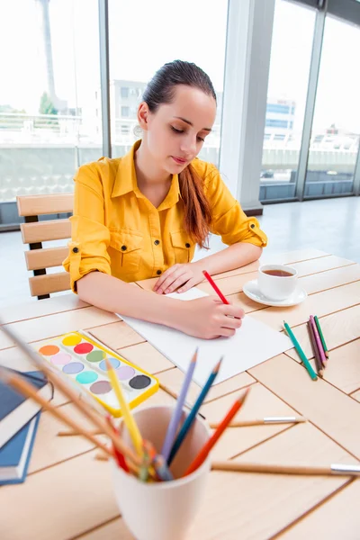 Young school gilr drawing pictures at home — Stock Photo, Image