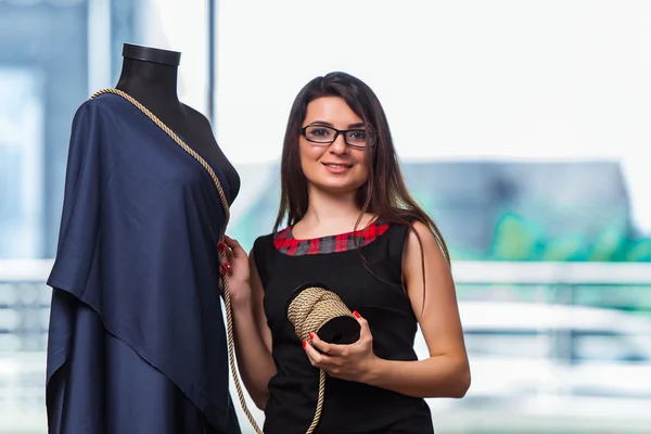 Mulher alfaiate trabalhando em roupas novas — Fotografia de Stock