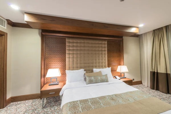 Το μοντέρνο ξενοδοχείο δωμάτιο με μεγάλο κρεβάτι — Φωτογραφία Αρχείου