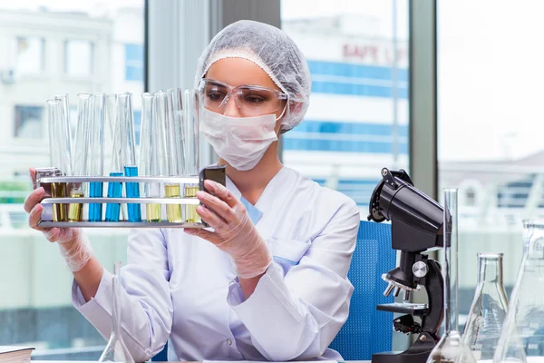 Young student working with chemical solutions in lab — Stock Photo, Image