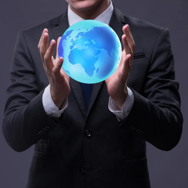 Young businessman in globalisation concept holding earth — Stock Photo, Image