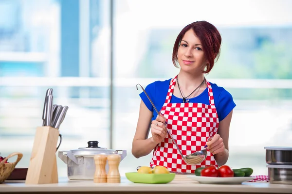 Woman preparing soup in the kitchen — Stock Photo, Image