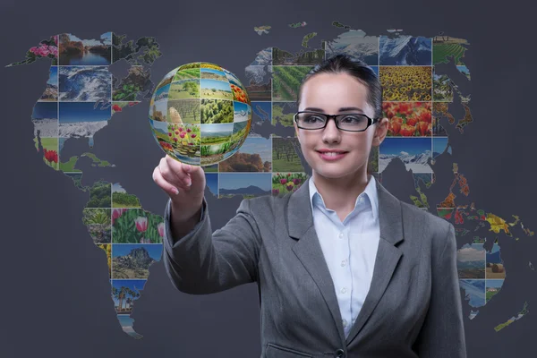 Woman pressing virtual button with nature photos — Stock Photo, Image