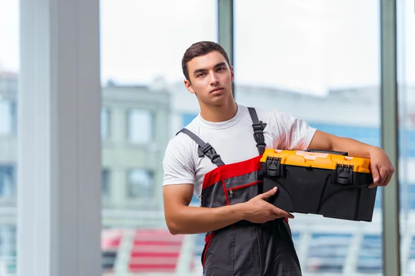 Ung tømrer arbejder på byggepladsen - Stock-foto