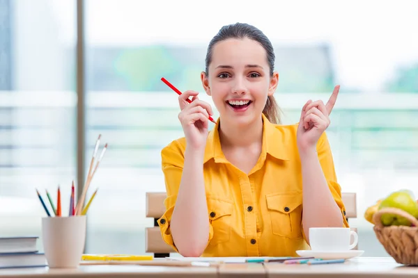 Jonge school gilr tekening van foto's thuis — Stockfoto