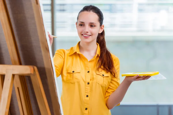 Young student artist drawing pictures in studio — Stock Photo, Image