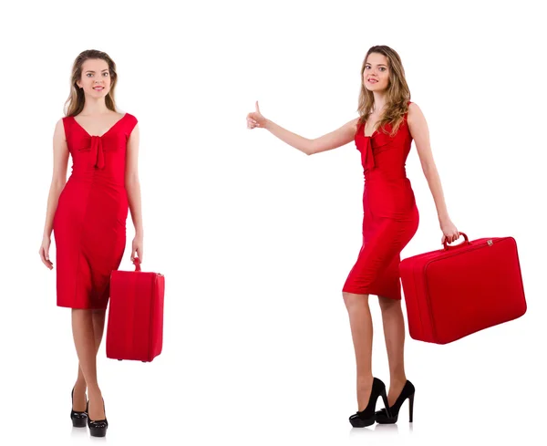 Young woman in red dress with suitcase isolated on white — Stock Photo, Image