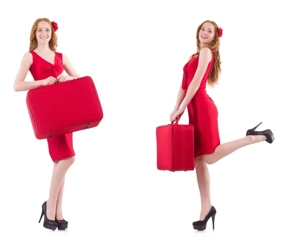 Jonge vrouw in rode jurk met koffer geïsoleerd op wit — Stockfoto