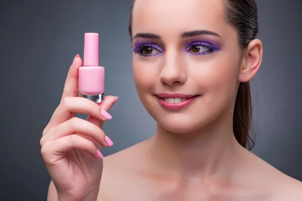 Mujer joven con lápiz labial en concepto de belleza — Foto de Stock