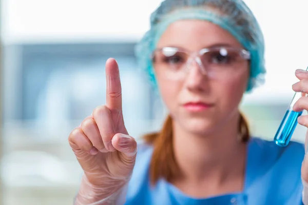 Jovem estudante trabalhando com soluções químicas em laboratório — Fotografia de Stock