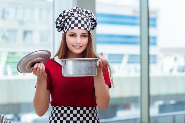 Young housewife preparing soup in kitchen — Stock Photo, Image
