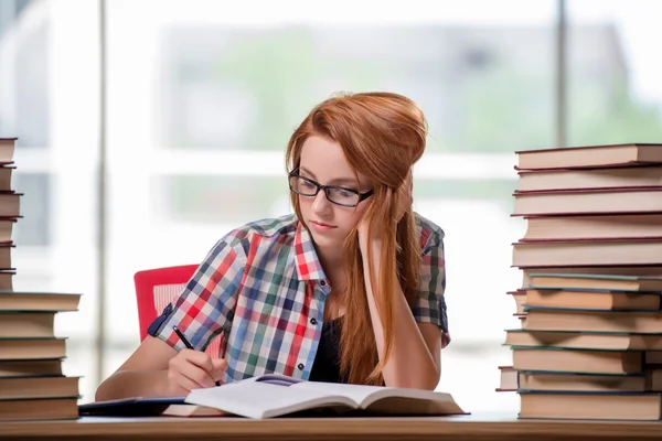 Estudante com pilhas de livros se preparando para exames — Fotografia de Stock