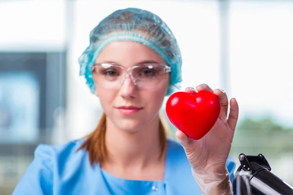 Doctor holding red heart in medical concept — Stock Photo, Image