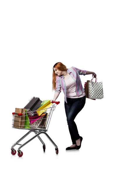 Woman with shopping cart and bags isolated on white — Stock Photo, Image