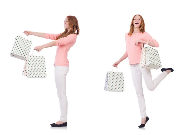 Jovem com sacos de compras isolados em branco — Fotografia de Stock