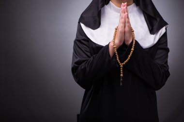 Religious nun in religion concept against dark background clipart