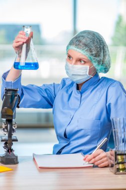 Kimyasal çözümler üzerinde çalışan deneyimli asistan