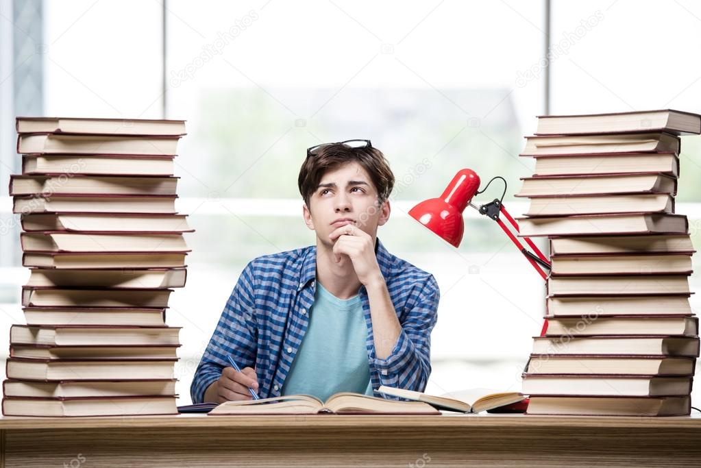 Student with lots of books preparing for exams