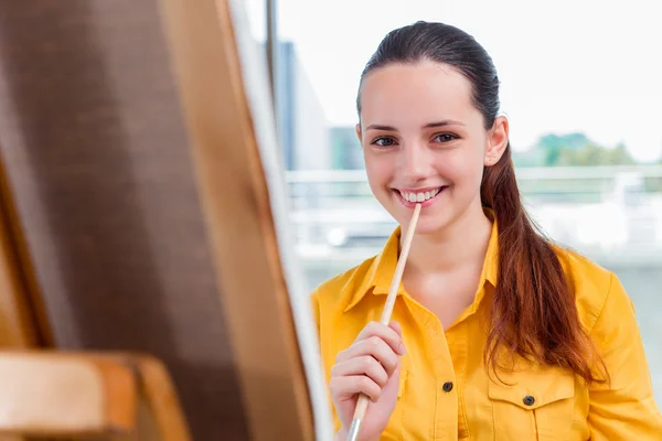 Young student artist drawing pictures in studio — Stock Photo, Image