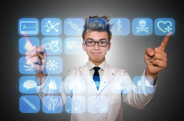 Man doctor pressing buttons with various medical icons — Stock Photo, Image