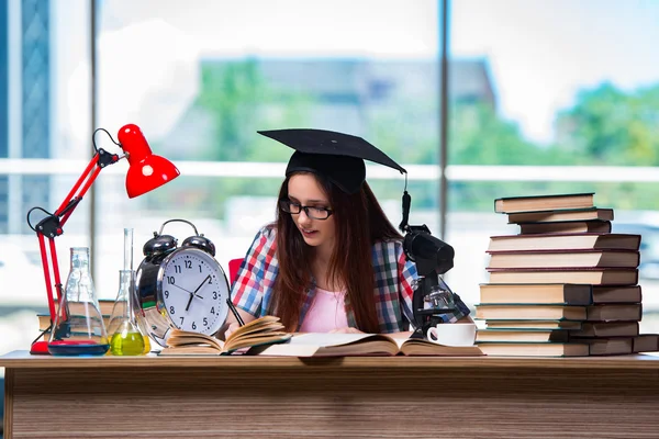 Young girl preparing for exams with large clock — Stock Photo, Image