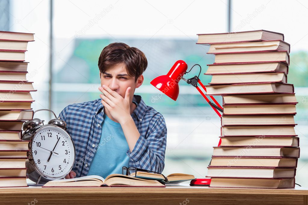 Student with lots of books preparing for exams