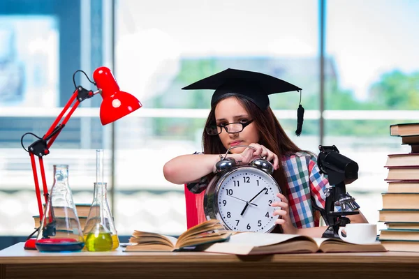 Young girl preparing for exams with large clock — Stock Photo, Image