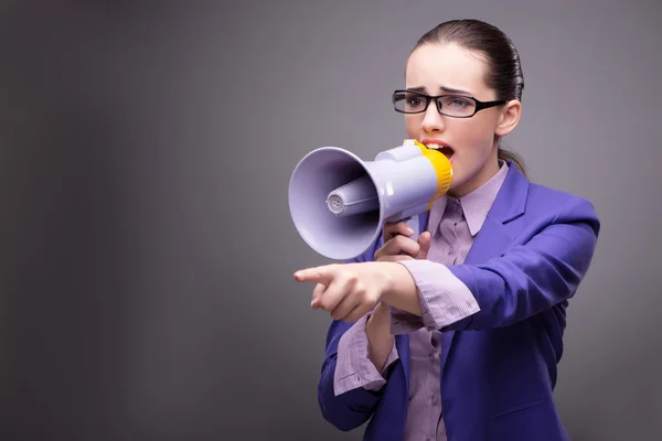 Young businesswoman yelling through loudspeaker — Stock Photo, Image