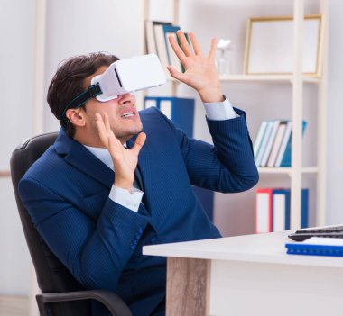 Çalışan ofiste sanal gerçeklik gözlüğü kullanıyor.