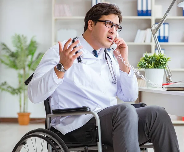 Disabled doctor on wheelchair working in hospital