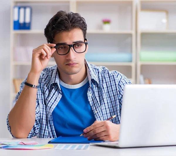 Joven diseñador trabajando en un nuevo proyecto y eligiendo colores — Foto de Stock