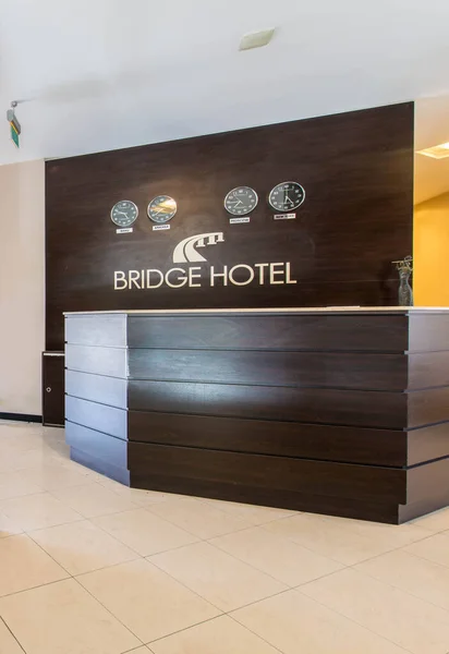 Hotel reception with desk and clocks — Stock Photo, Image