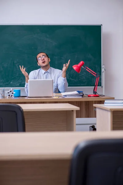 Jonge mannelijke leraar in de voorkant van groene boord — Stockfoto