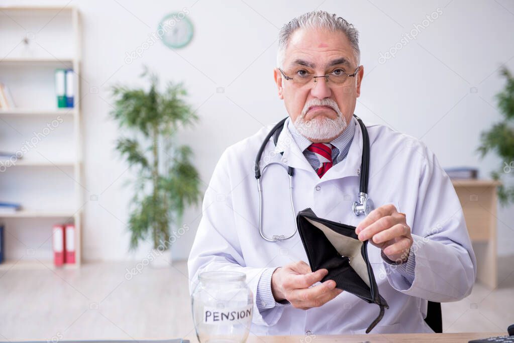 Old male doctor in retirement concept