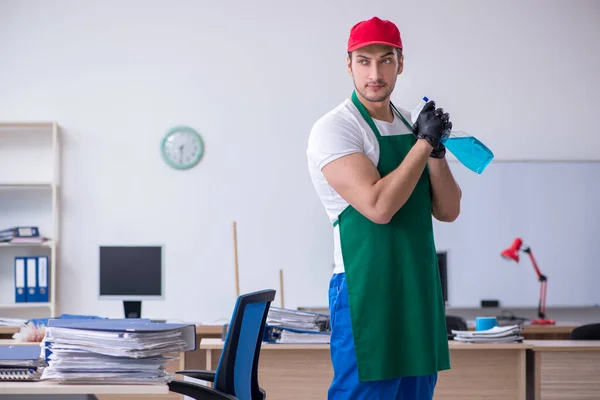 Joven contratista masculino limpiando la oficina — Foto de Stock