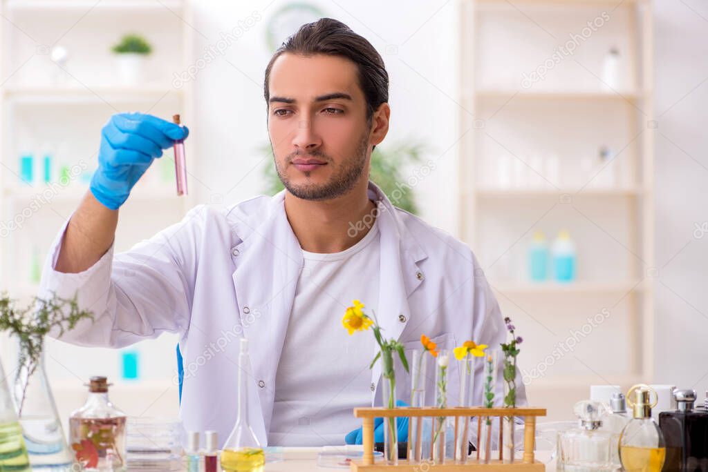 Young male chemist in perfume synthesis concept