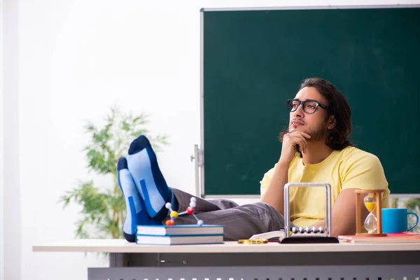 Jonge mannelijke student natuurkundige voorbereiding voor examens in de klas — Stockfoto