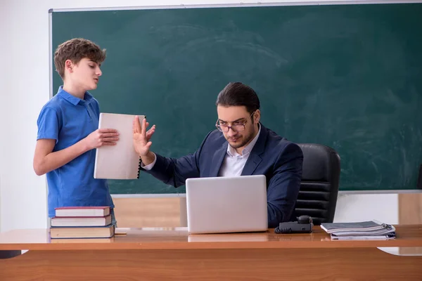 Genç erkek öğretmen ve okul çocuğu sınıfta. — Stok fotoğraf